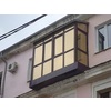 Пример работ, выполненных мастерами компании Белый Город - балкон с остеклением от пола до потолка, тонированные стекла.